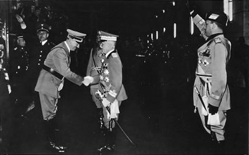 King Victor Emmanuel III and Benito Mussolini welcome Adolf Hitler in Rome's train station